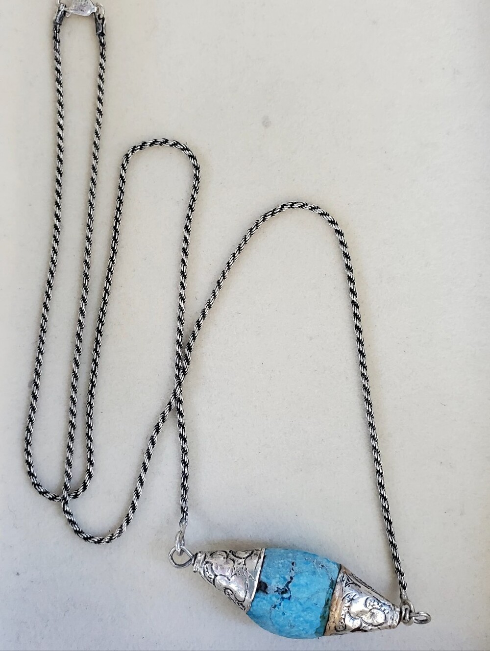 "Turquoise-Coloured Stone Pendant Necklace with Ornate Silver Caps